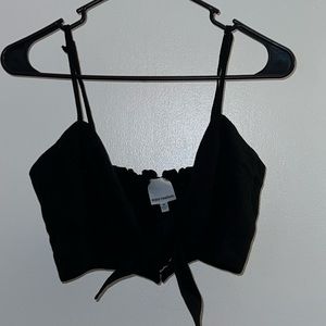 Very cute black crop top from local boutique. Has a tie and snaps in the front.
